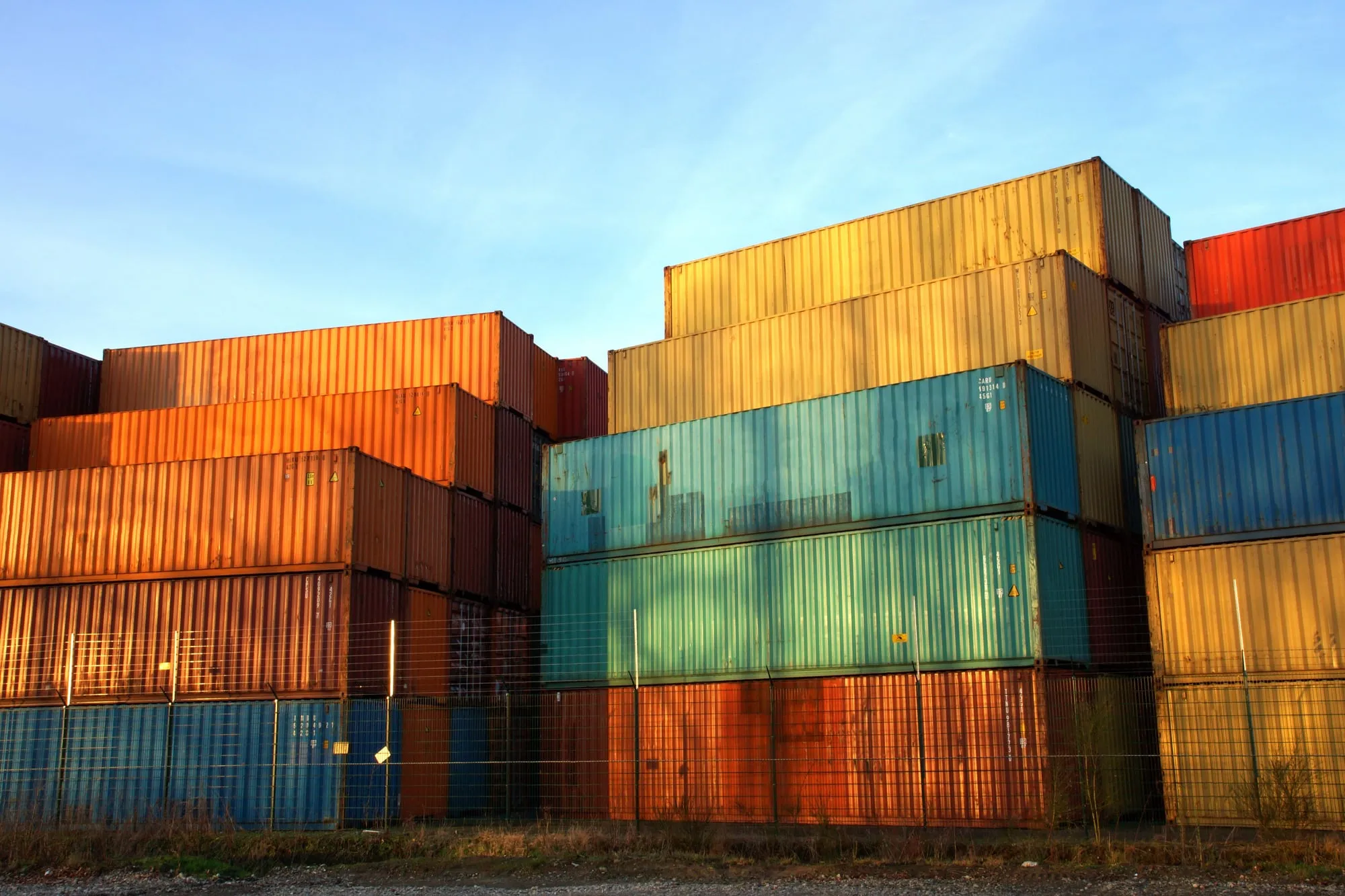 Stacked shipping containers under a deep red tint