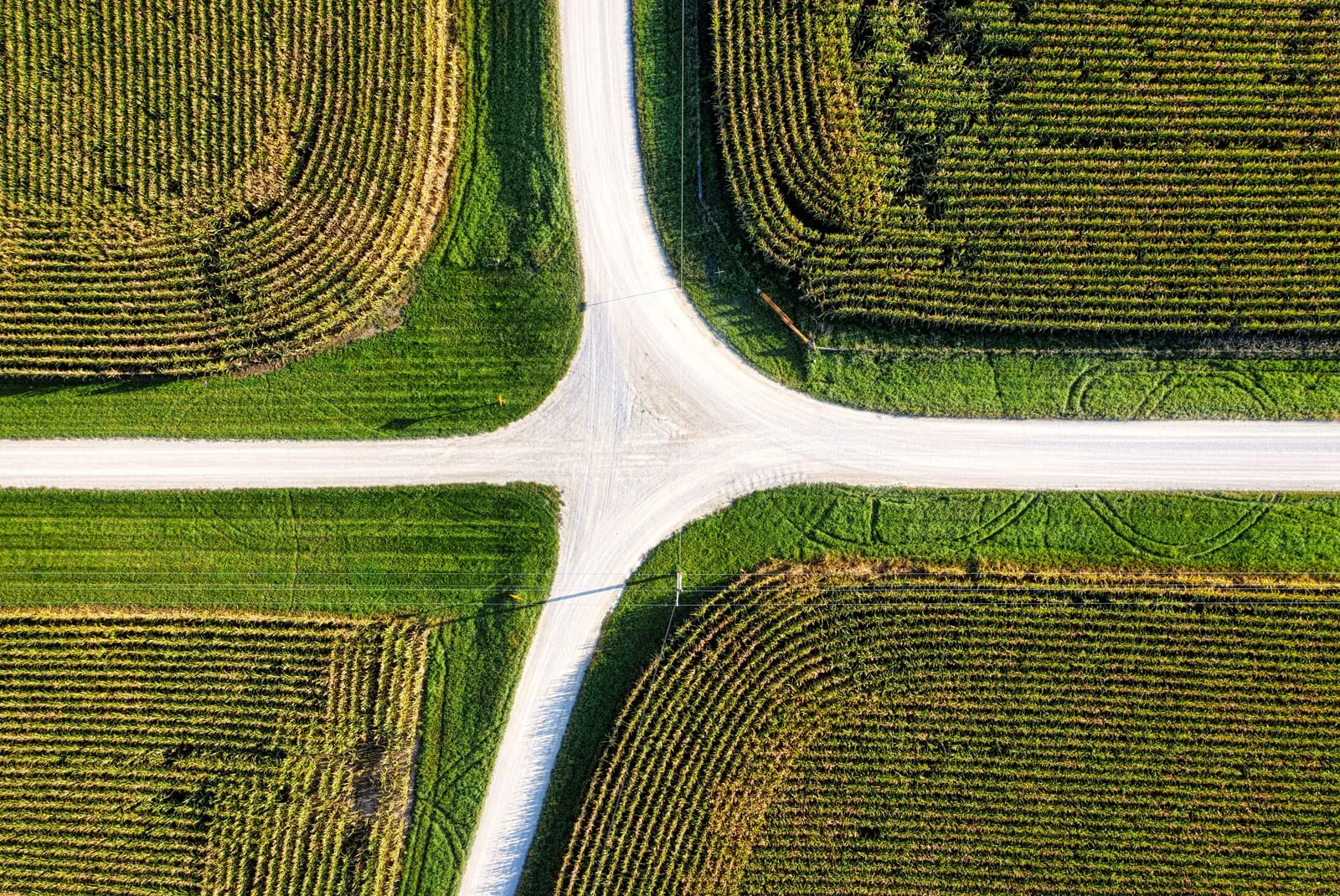 Aerial view of a crossroads between green fields
