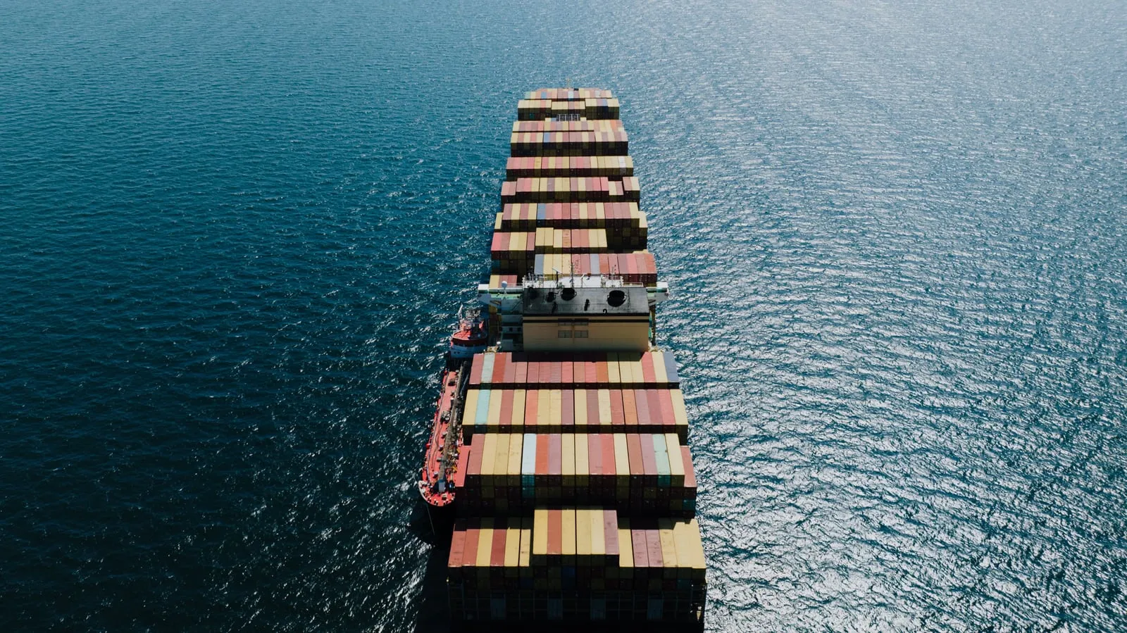 A cargo ship on open water seen from above